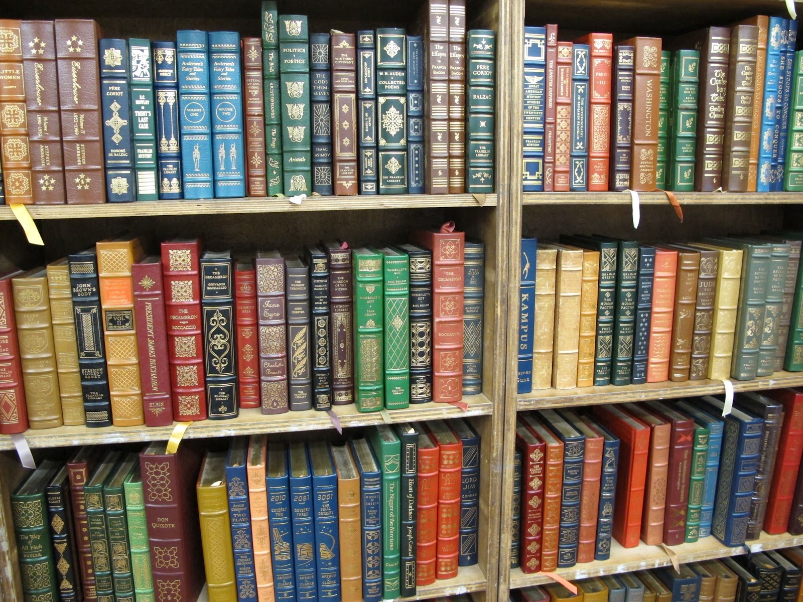 a close-up of a bookshelf filled with different color books